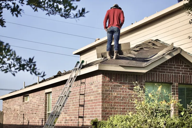 Professional roofer working on a residential roof in Matville